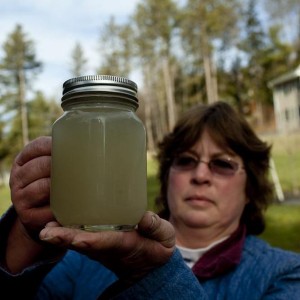 A citizen examines polluted water from her drinking water supply. Source: sites.psu.edu