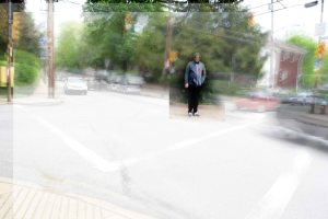Man waits to cross the Wilkins Ave in Pittsburgh, PA